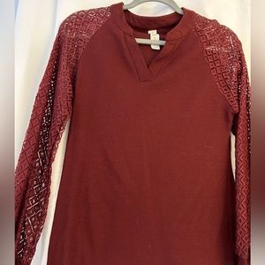 Burgundy v neck with lace sleeves.